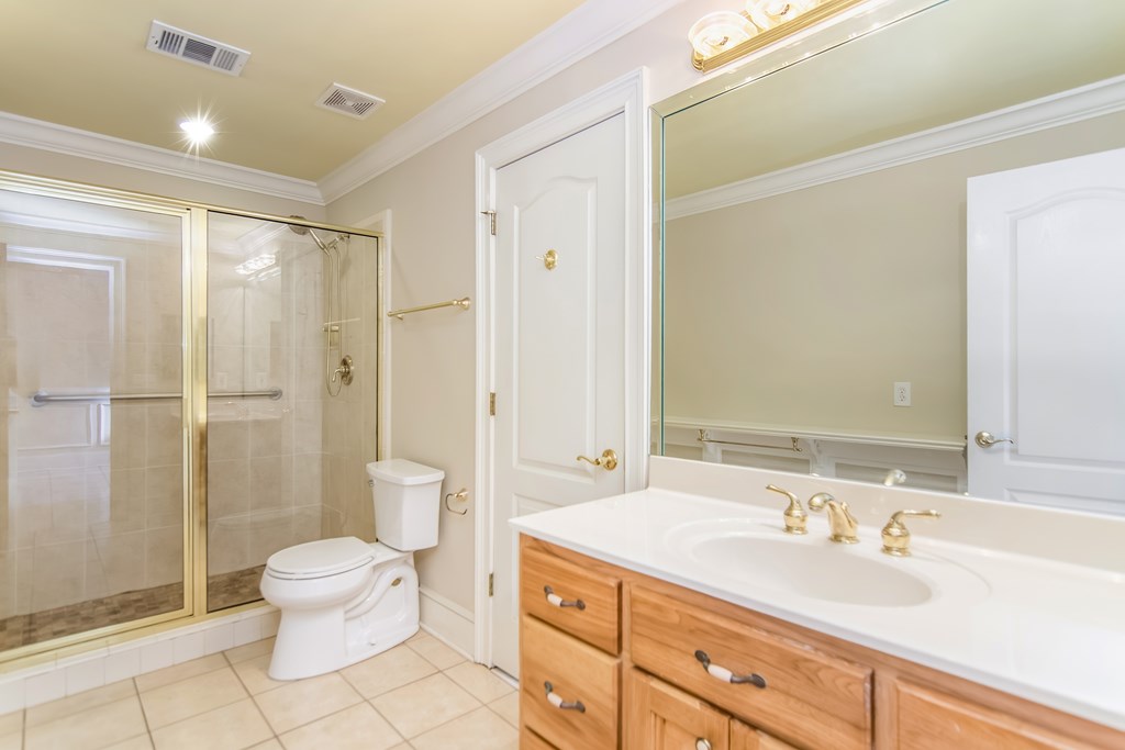 8010 Scudder Way Ball Ground, GA 30107 - Photo 27 of 57 a spacious bathroom with a double vanity sink toilet mirror and shower