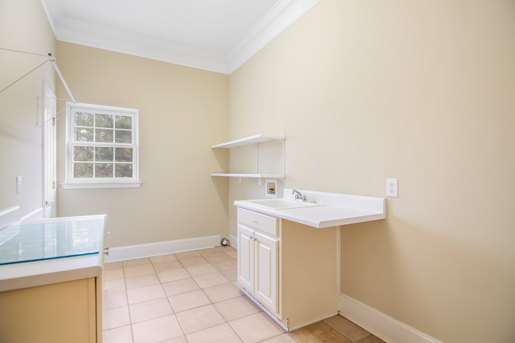 8010 Scudder Way Ball Ground, GA 30107 - Photo 41 of 57 a utility room with a sink washer and dryer