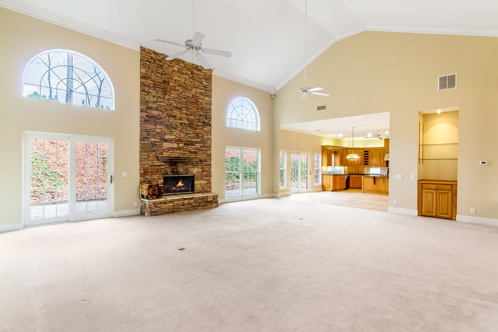 8010 Scudder Way Ball Ground, GA 30107 - Photo 7 of 57 a view of an empty room with a fireplace and a window