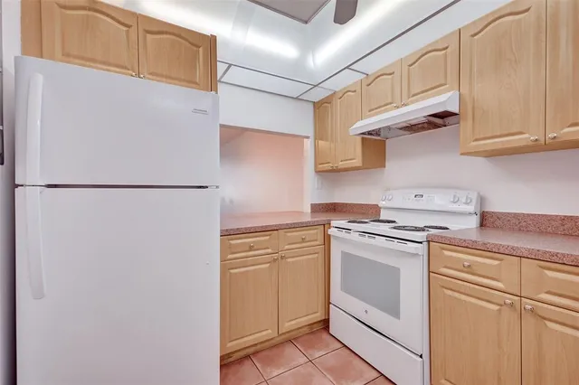 a kitchen with stainless steel appliances granite countertop white refrigerator stove a sink and dishwasher