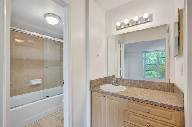 a bathroom with a sink a vanity and a mirror