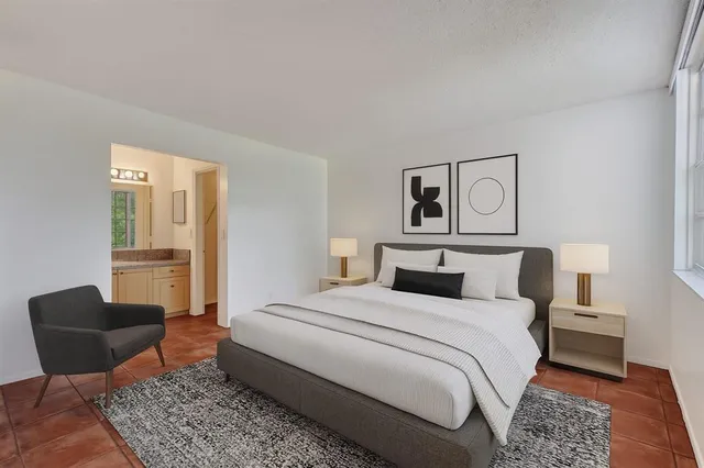 a bedroom with a bed and chair