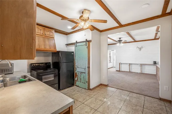 a kitchen with stainless steel appliances granite countertop a refrigerator a sink and dishwasher