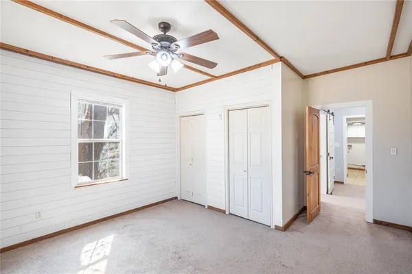 a view of a livingroom with a ceiling fan and window