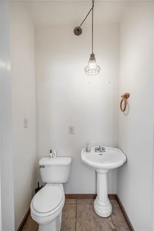 a bathroom with a sink toilet and a mirror