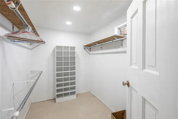 a view of walk in closet with empty racks