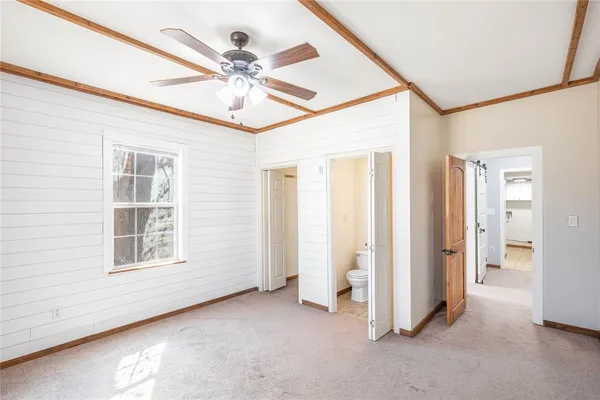 a view of a livingroom with a ceiling fan and window