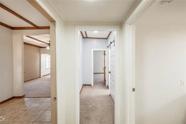 a view of a hallway with a room