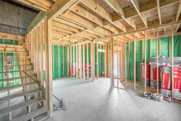 a view of a room with floor to ceiling windows and wooden walls