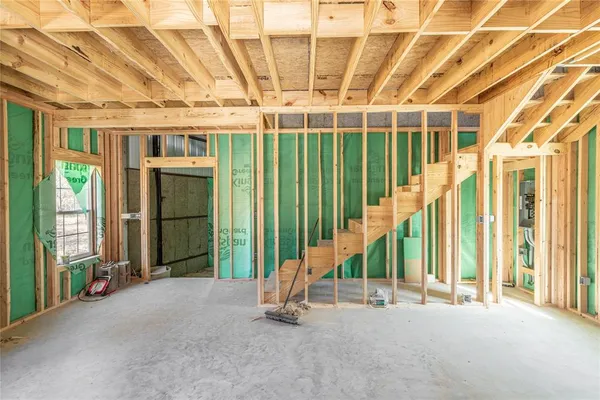 a view of a hall with wooden floor and windows
