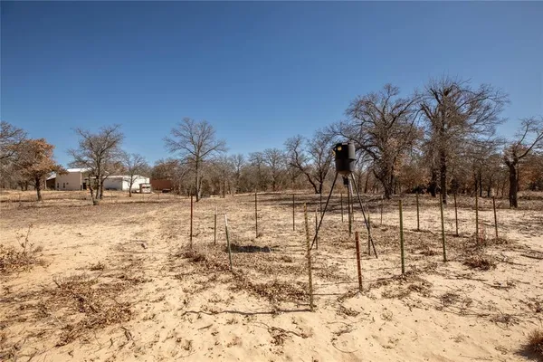 a backyard of a house with fire pit and outdoor seating