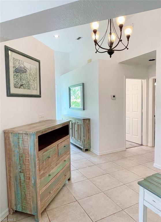 2037 West Crown Pointe Boulevard Naples, FL 34112 - Photo 13 of 24 a kitchen with a cabinets and chandelier