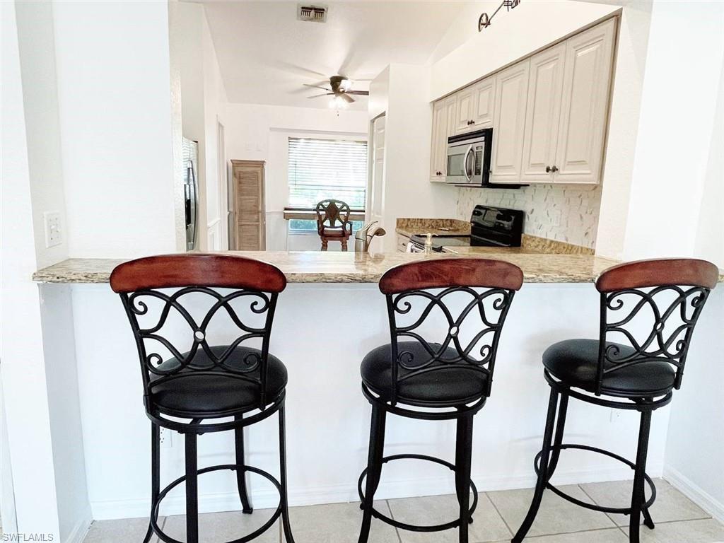 2037 West Crown Pointe Boulevard Naples, FL 34112 - Photo 17 of 24 a dining room with furniture and window