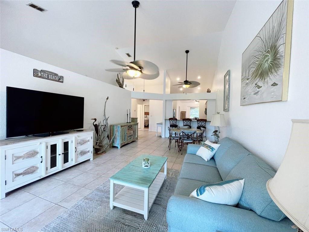 2037 West Crown Pointe Boulevard Naples, FL 34112 - Photo 3 of 24 a living room with furniture and a flat screen tv