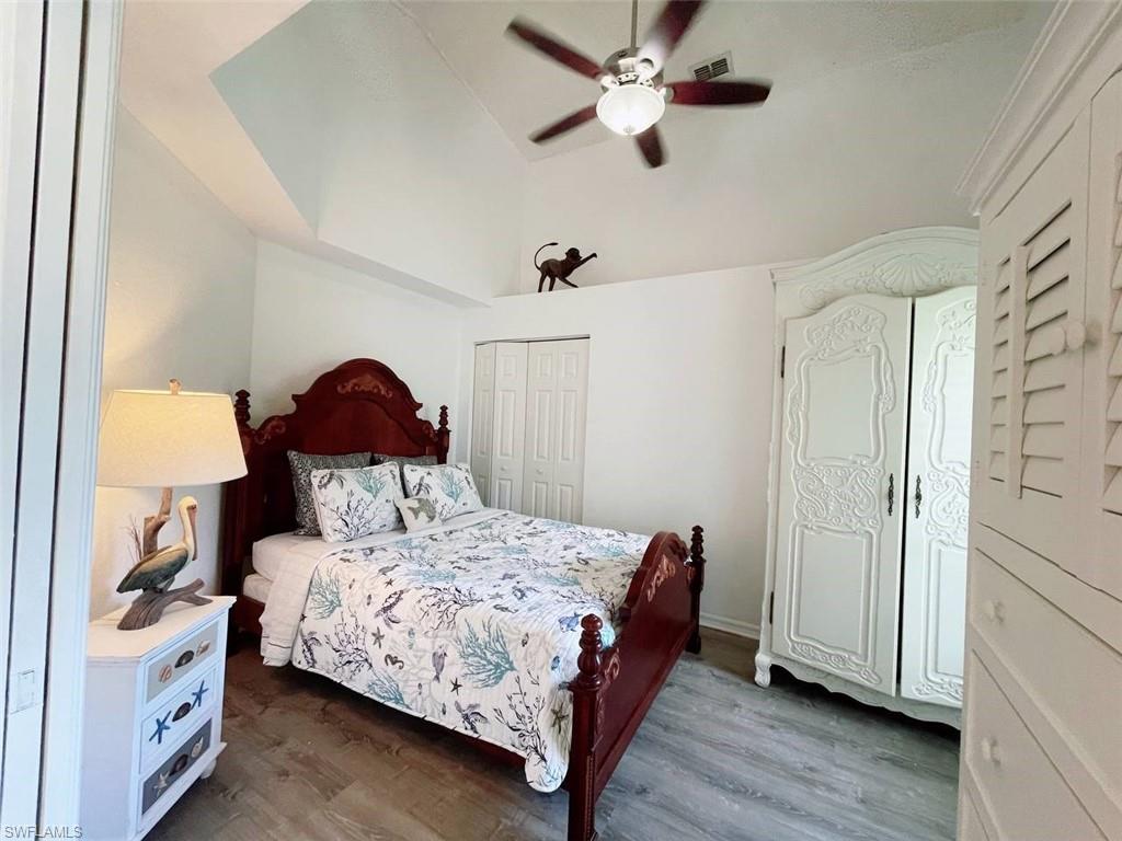 2037 West Crown Pointe Boulevard Naples, FL 34112 - Photo 7 of 24 a bedroom with a bed and a chandelier