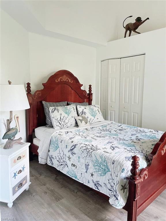 2037 West Crown Pointe Boulevard Naples, FL 34112 - Photo 8 of 24 a bedroom with a bed and a chandelier