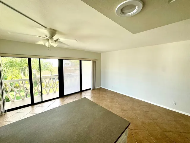 a large kitchen with a sink and a large window