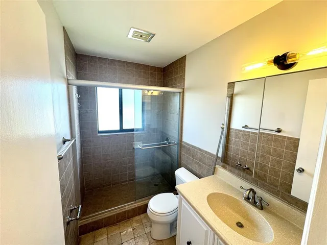 a kitchen with a refrigerator a sink and cabinets