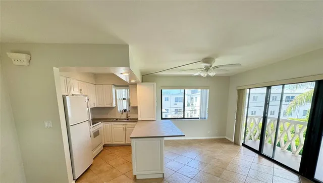 a view of a kitchen with a sink and cabinets