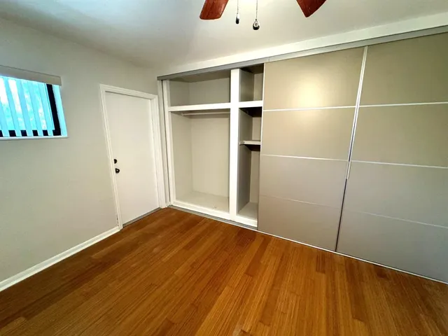 a view of empty room with a fan