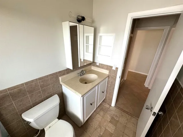 a bathroom with a glass door shower and a sink