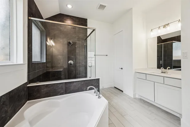 a bathroom with a bathtub and a sink