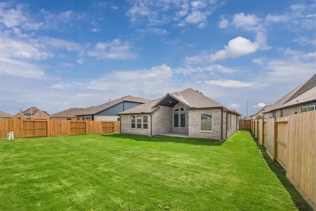 a view of a house with a big yard and large trees