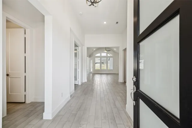 a view of hallway with wooden floor