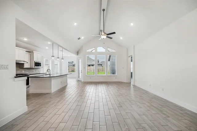 a view of kitchen with sink and wooden floor