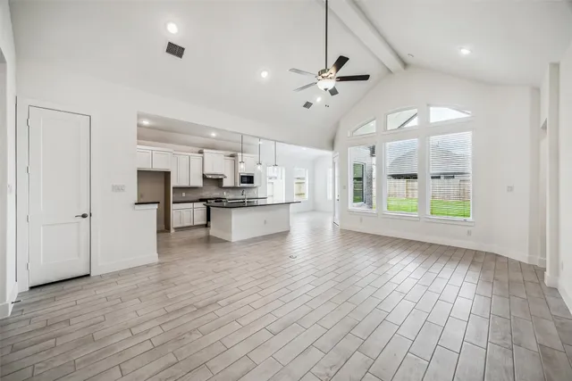 a view of kitchen with wooden floor electronic appliances and window
