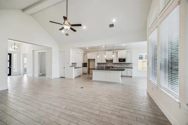 a view of kitchen dining table chairs microwave and cabinets