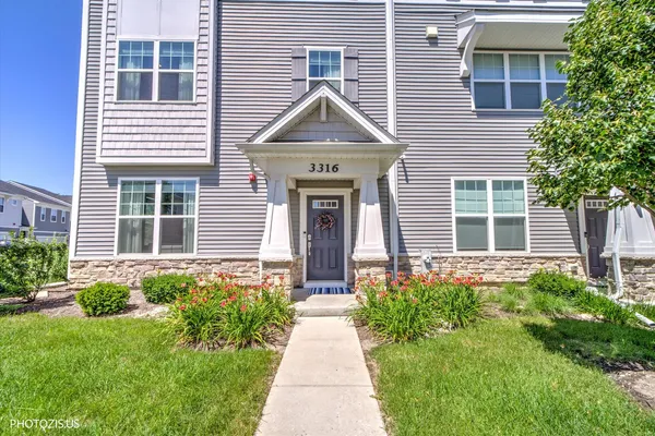 a front view of a house with garden and porch
