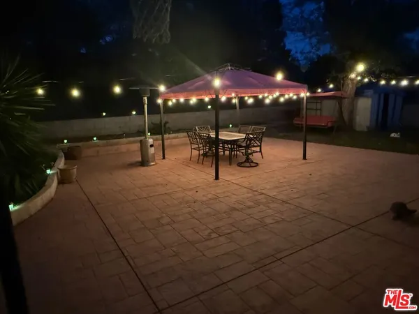a patio with tables and chairs