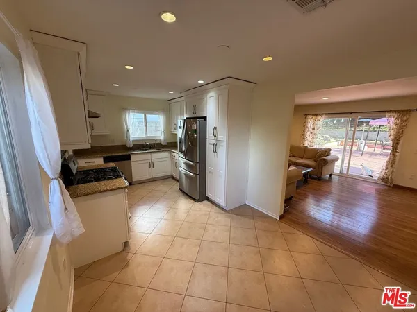 a kitchen with a sink and a refrigerator