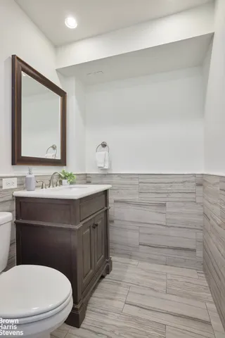 a bathroom with a sink a toilet and mirror