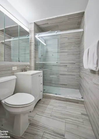 a bathroom with a toilet and a shower