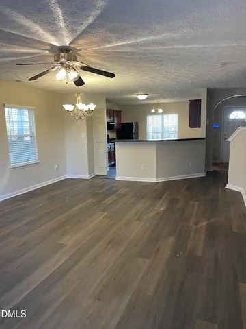 a kitchen with stainless steel appliances granite countertop a stove a refrigerator and a microwave oven