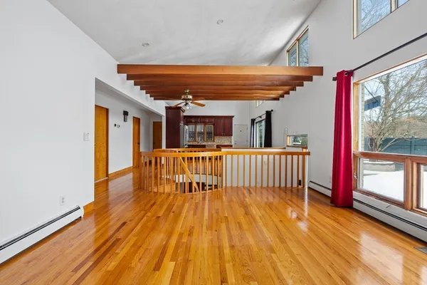 a view of a porch with wooden floor and iron stairs