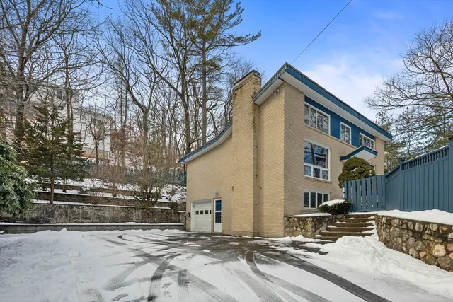 a view of a house with snow on the road