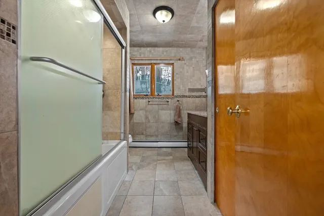 a bathroom with a glass shower door