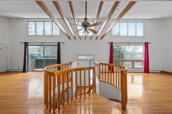 a view of staircase with a large window and wooden floor