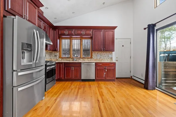 a kitchen with stainless steel appliances granite countertop a refrigerator and a stove
