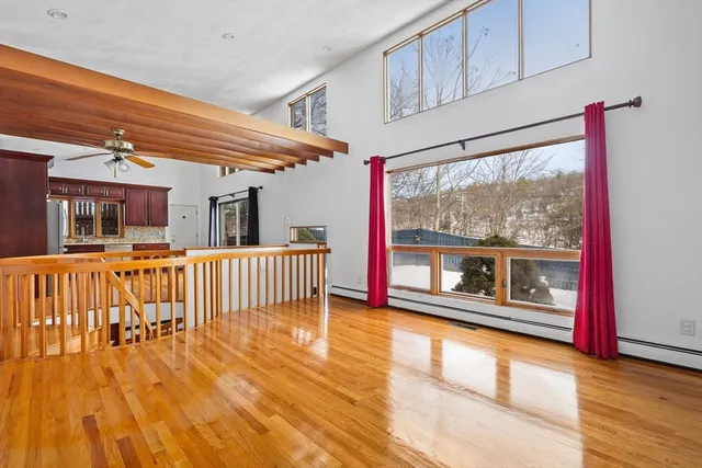 a view of a room with wooden floor and windows