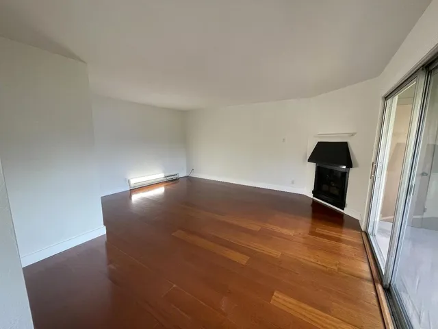 an empty room with wooden floor