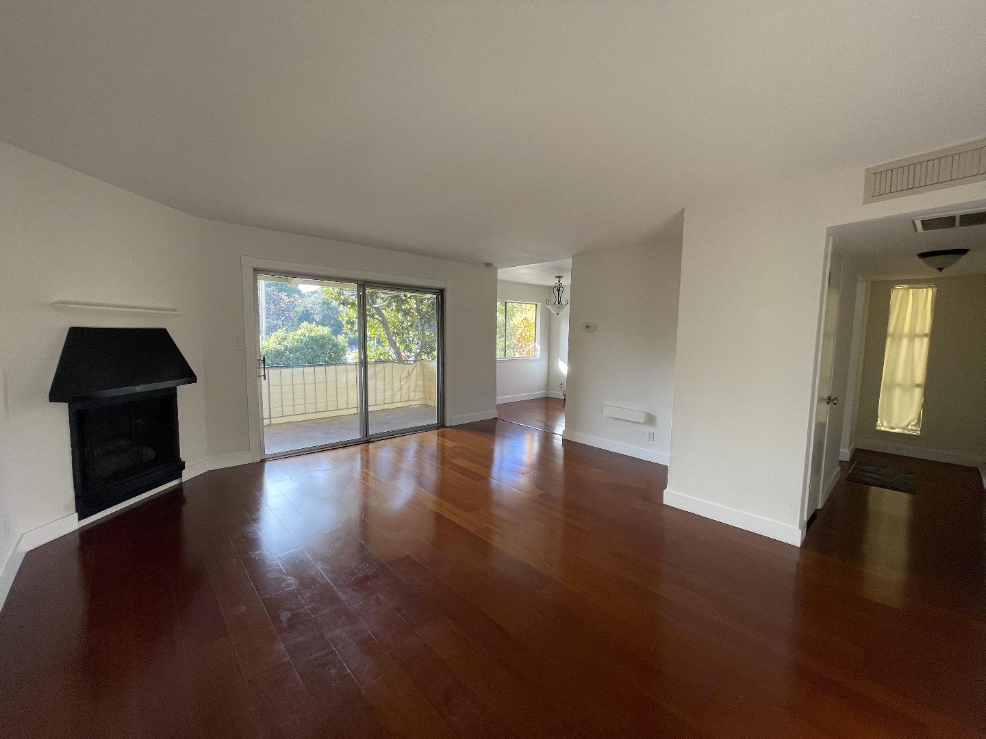 420 Alberto Way, Unit 5 Los Gatos, CA 95032 - Photo 9 of 11 a view of an empty room with wooden floor and a window