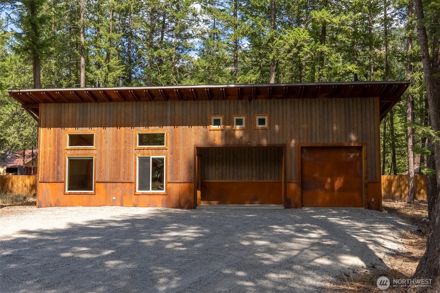 16 Littell Road Mazama, WA 98833 - Photo 2 of 40 a front view of a house with a garage