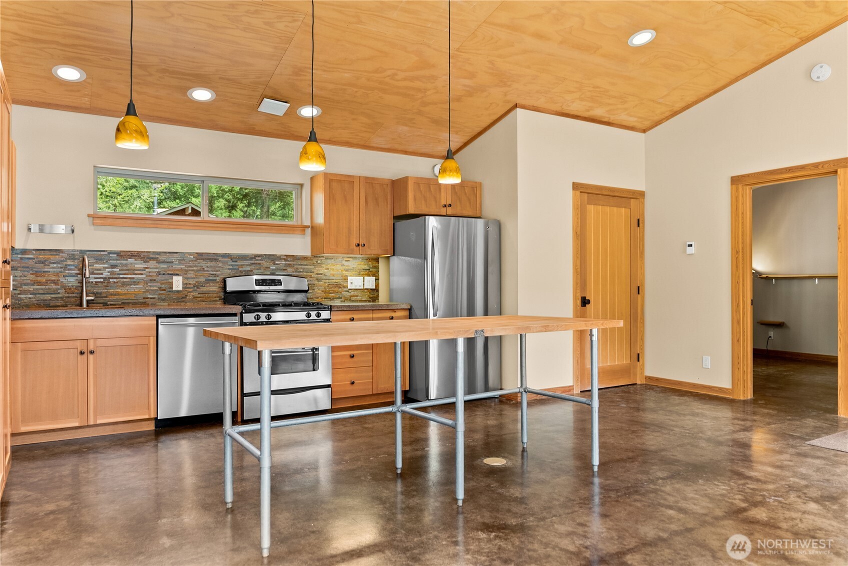 16 Littell Road Mazama, WA 98833 - Photo 24 of 40 a kitchen with stainless steel appliances granite countertop a stove a sink and white cabinets with wooden floor