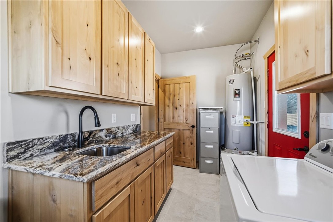 10374 East Happy Trails Road Kingman, AZ 86401 - Photo 41 of 68 a kitchen with stainless steel appliances granite countertop a sink and dishwasher a refrigerator with wooden cabinets