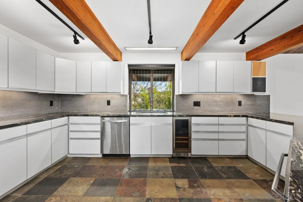 30830 Ranch Creek Road Valley Center, CA 92082 - Photo 11 of 50 a kitchen with white cabinets and white appliances