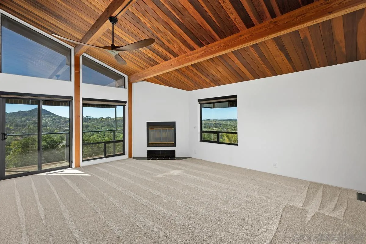 30830 Ranch Creek Road Valley Center, CA 92082 - Photo 17 of 50 a view of an empty room with wooden floor and a window